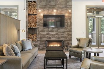 a living room with couches and chairs and a fireplace
